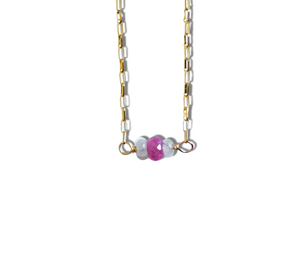 Gorgeous faceted pink sapphire surrounded by rainbow moonstones adorn this gold chain.18" length.