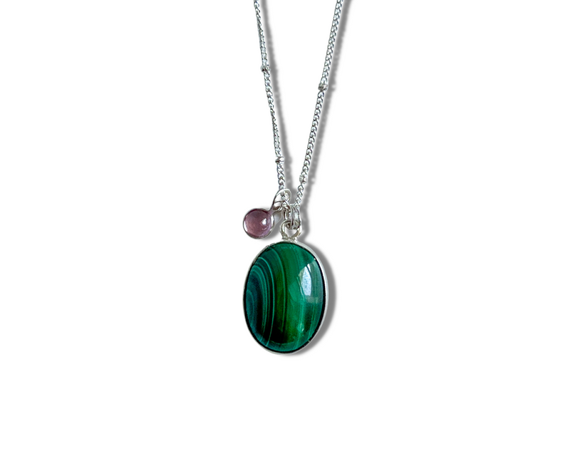 Beautiful green malachite gemstone set in sterling silver with a lab-created pink sapphire accent on a sterling silver chain necklace.Adjustable from 18" to 20".Made in Long Beach, CA.